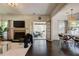 Open-concept living room boasts hardwood floors, a fireplace, and access to a sunroom at 2366 Battle Forest Sw Dr, Marietta, GA 30064