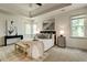 Bright main bedroom featuring a tray ceiling, bay windows, and a king-size bed at 2366 Battle Forest Sw Dr, Marietta, GA 30064