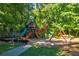 Neighborhood playground with swings, slides, climbing area, and mature trees at 2366 Battle Forest Sw Dr, Marietta, GA 30064
