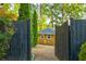 View of backyard shed with wooden fence, pea gravel, and mature landscaping at 2366 Battle Forest Sw Dr, Marietta, GA 30064