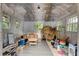 Interior of the shed with corrugated metal walls, several windows and plank flooring at 2366 Battle Forest Sw Dr, Marietta, GA 30064