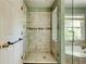 Bathroom features a walk-in shower with glass door and tile surround at 2366 Battle Forest Sw Dr, Marietta, GA 30064