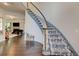 Elegant curved staircase with patterned carpet and hardwood flooring at 2366 Battle Forest Sw Dr, Marietta, GA 30064