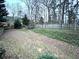 Large, fenced backyard with a mix of open space and mature trees, perfect for outdoor activities at 6745 Fairfield Trce, Suwanee, GA 30024