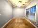 Bedroom boasts hardwood floors, blue walls, and natural light from large window, perfect for relaxing at 6745 Fairfield Trce, Suwanee, GA 30024