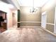 Open dining area with chandelier, large windows, and stylish accents, great for gathering and entertaining at 6745 Fairfield Trce, Suwanee, GA 30024