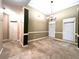 Inviting dining area with modern lighting, large windows, and neutral decor, ready for your personal touch at 6745 Fairfield Trce, Suwanee, GA 30024