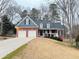 Charming brick home with a two-car garage and welcoming front porch; perfect for suburban living at 6745 Fairfield Trce, Suwanee, GA 30024