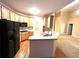 Well-equipped kitchen with wooden cabinets, modern appliances, and breakfast bar, offering functionality and style at 6745 Fairfield Trce, Suwanee, GA 30024