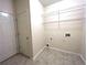 Functional laundry room features wire shelving and tiled floors for added convenience at 6745 Fairfield Trce, Suwanee, GA 30024