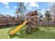 Backyard features a wooden playset with a slide and ladder at 1495 Oak Springs Dr, Marietta, GA 30066