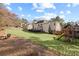 Expansive backyard features a well-maintained lawn, playset, and outdoor seating area at 1495 Oak Springs Dr, Marietta, GA 30066