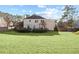Large backyard with a manicured lawn, a deck, mature trees, and a slide at 1495 Oak Springs Dr, Marietta, GA 30066