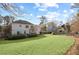 Beautiful backyard featuring a sprawling lawn, mature trees, a deck, and a play area at 1495 Oak Springs Dr, Marietta, GA 30066