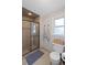 This bathroom features a glass shower, wicker basket, and neutral color scheme at 1495 Oak Springs Dr, Marietta, GA 30066