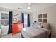 Cozy bedroom featuring blue curtains, red dresser, fan, and overhead lighting at 1495 Oak Springs Dr, Marietta, GA 30066