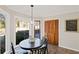 Inviting dining area with a round table, decorative lighting, and a door leading to the backyard at 1495 Oak Springs Dr, Marietta, GA 30066