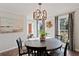 Bright dining room features a large window, modern chandelier, and cozy seating for Gathering meals at 1495 Oak Springs Dr, Marietta, GA 30066