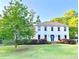 Beautiful two-story home with a bright green lawn and meticulously kept landscaping at 1495 Oak Springs Dr, Marietta, GA 30066