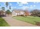 Side view of home with a two-car garage and a long driveway at 1495 Oak Springs Dr, Marietta, GA 30066