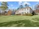 Expansive green lawn in front of this two-story home with a brick entry at 1495 Oak Springs Dr, Marietta, GA 30066
