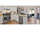 Bright kitchen features white cabinets, stainless steel appliances, and a cozy breakfast nook with backyard views at 1495 Oak Springs Dr, Marietta, GA 30066