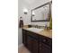 Stylish powder room with granite countertop, dark wood cabinets, and modern fixtures at 1495 Oak Springs Dr, Marietta, GA 30066