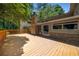 Expansive back deck with stone chimney and french doors leading to the interior at 1690 Trotters Ln, Stone Mountain, GA 30087