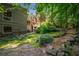 A lush backyard blends into a wooded area with a walking path at 1690 Trotters Ln, Stone Mountain, GA 30087