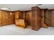 Basement area with a bar, wood paneling, a staircase, and tile flooring at 1690 Trotters Ln, Stone Mountain, GA 30087
