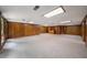Large finished basement featuring wood paneling, carpeted floors, and good natural light at 1690 Trotters Ln, Stone Mountain, GA 30087
