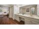 Dual vanities, marble countertop, and wooden floors in a well-lit bathroom connected to the bedroom at 1690 Trotters Ln, Stone Mountain, GA 30087