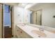 Bright bathroom featuring double sinks, a large mirror, and a view into another room at 1690 Trotters Ln, Stone Mountain, GA 30087