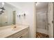 Bathroom featuring a large mirror, sconces, an elongated sink and shower with glass doors at 1690 Trotters Ln, Stone Mountain, GA 30087