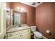 Powder room with vanity, granite countertop, and patterned wallpaper creates a stylish space at 1690 Trotters Ln, Stone Mountain, GA 30087