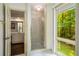 Bathroom with glass-enclosed shower and a view of a backyard wooded view at 1690 Trotters Ln, Stone Mountain, GA 30087