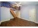 A unique bedroom with a loft, wooden railings, and a spacious layout with wood-look floors at 1690 Trotters Ln, Stone Mountain, GA 30087