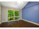 A naturally lit bedroom with high ceilings, wood floors and a wall of windows with a beautiful tree view at 1690 Trotters Ln, Stone Mountain, GA 30087