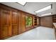 A paneled bonus room features wood accents, built-in shelving, and natural light from a window overlooking the wooded property at 1690 Trotters Ln, Stone Mountain, GA 30087