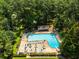 Aerial view of the community pool with plenty of lounge chairs and umbrellas at 1690 Trotters Ln, Stone Mountain, GA 30087