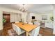 Dining room with chandelier, dark wood floors, a table set for six, and views into the living room at 1690 Trotters Ln, Stone Mountain, GA 30087