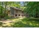 Exterior view of the home, with a large front yard surrounded by mature trees at 1690 Trotters Ln, Stone Mountain, GA 30087