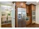 Kitchen boasts stainless steel refrigerator and microwave, with dining room visible through doorway at 1690 Trotters Ln, Stone Mountain, GA 30087