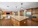 Open kitchen featuring stainless steel appliances, a large island with seating, and seamless flow to the living area at 1690 Trotters Ln, Stone Mountain, GA 30087