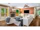 Bright living room with hardwood floors, stone fireplace, and a comfortable seating arrangement at 1690 Trotters Ln, Stone Mountain, GA 30087