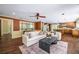Spacious living room featuring wood floors, decorative windows, and an open layout to the kitchen at 1690 Trotters Ln, Stone Mountain, GA 30087