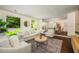 Bright living room with a large window, wood floors, and views to the dining room at 1690 Trotters Ln, Stone Mountain, GA 30087
