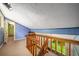 Upper level loft with carpeted floor, wooden railing, and views of wooded property at 1690 Trotters Ln, Stone Mountain, GA 30087