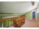 Upper level loft with carpeted floor, wooden railing, and views to bedroom at 1690 Trotters Ln, Stone Mountain, GA 30087