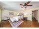 A beautifully staged main bedroom featuring a plush bed, chair and elegant decor at 1690 Trotters Ln, Stone Mountain, GA 30087